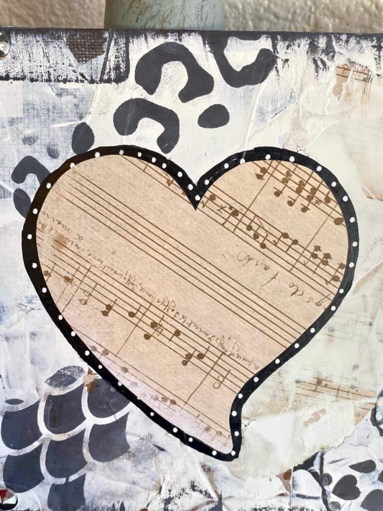 Mixed media funky heart with music sheet paper.
