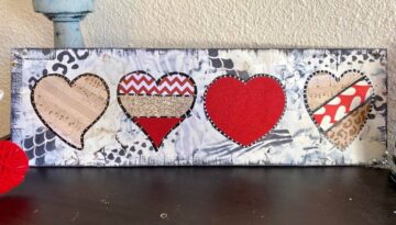 Mixed Media Funky Valentine's Day Hearts crafty decor idea for February 14th with red, leopard, and black and white background on a long wooden board.