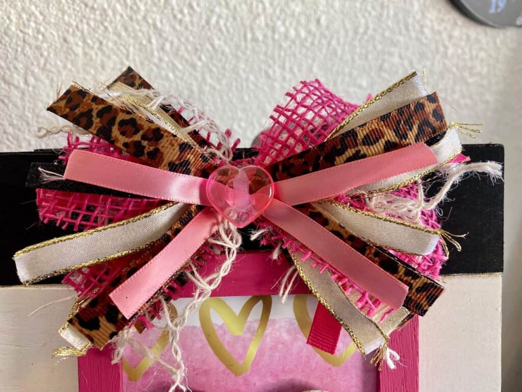 Messy bow with leopard, pink, white, gold and a pink heart center.