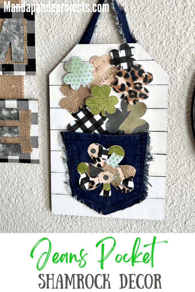 Patchwork Shamrock on the back of a jeans pocket with smaller shamrocks spilling out of the pocket that are green glitter, leopard print, buffalo check, music sheet, and burlap with a faux shiplap background, with a strip of jeans as the hanger.