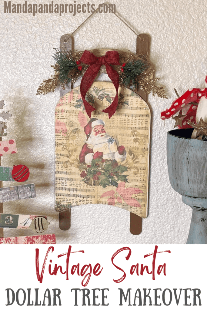 Dollar Tree Vintage Santa Sleigh with craft printable decoupaged onto wood and old music sheet background DIY Christmas Decor