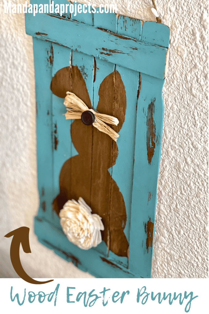 Reverse stencil wood bunny easter diy decor made with paint sticks and a sola wood flower tail and pip berry hanger.