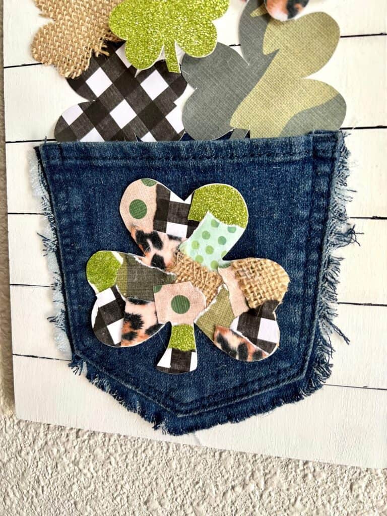 Patchwork shamrock on the back of a jeans pocket that was upcycled into St. Patricks Day Decor.