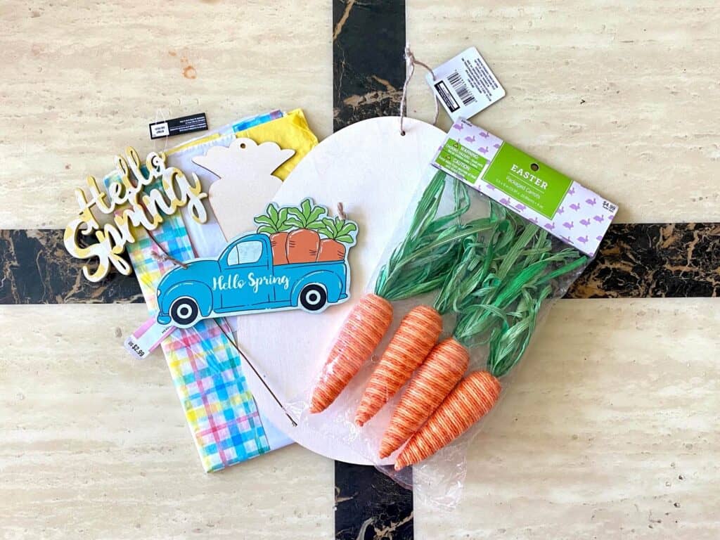Supplies needed to make a Dollar Tree Hello Spring Truck DIY for easter or spring carrots pictured that were not used in the craft.