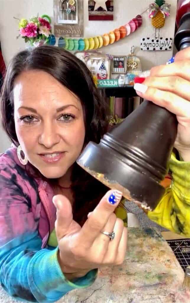 Amanda pointing out he rusted part at the bottom of the chunky candlestick.