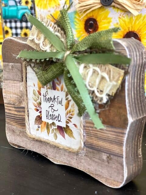 Dollar Tree Mini back of the calendar 'Thankful and Blessed" tiered tray decor block with a faux wood finish and mini bow.