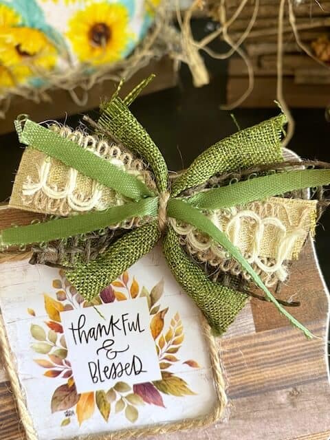 Mini bow or bow-tie with green and brown burlap, gold, and thin green ribbon.