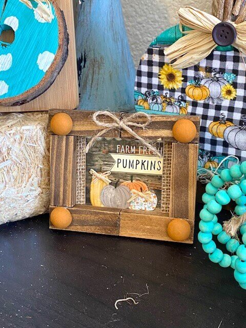 Dollar Tree Mini Calendar jenga block Frame with the Farm Fresh Pumpkins print from the back for decor on a a fall inspired tiered tray.