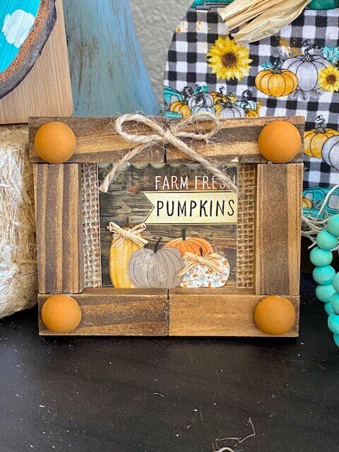 Dollar Tree Calendar jenga block Frame with the Farm Fresh Pumpkins mini print from the back for decor on a a fall inspired tiered tray.