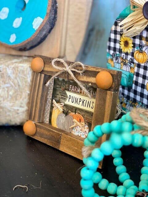 Dollar Tree Mini Calendar jenga block Frame with the Farm Fresh Pumpkins print from the back for decor on a a fall inspired tiered tray.