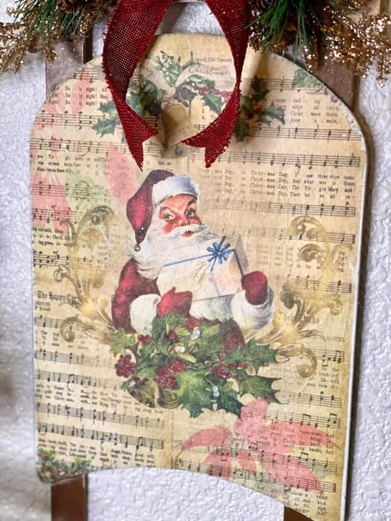 Close up of the vintage santa printable with old music sheet background.