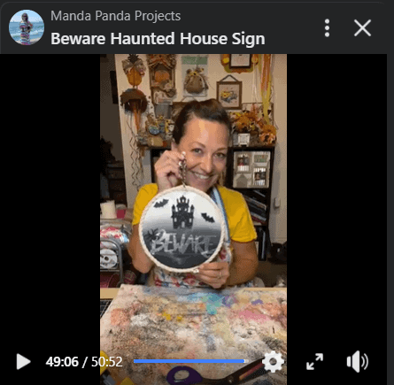 Amanda holding the completed project in a facebook live thumbnail.