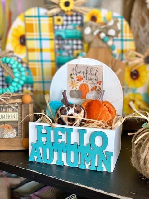 Dollar Tree Hello Autumn mini tiered tray pumpkin crate with the Dollar Tree "Thankful and Blessed" print from the back of the calendar with an orange, teal, and leopard print pumpkin.