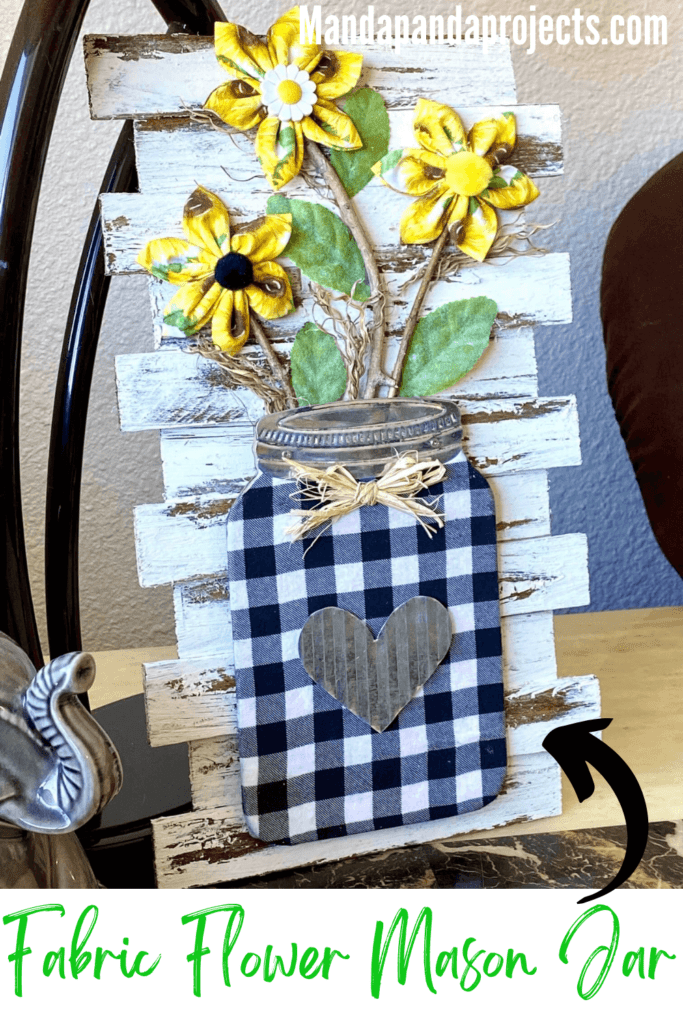 DIY Fabric Sunflower Mason Jar decor with buffalo check fabric and wooden shims on a chippy paint background. for spring and summer crafty decor.