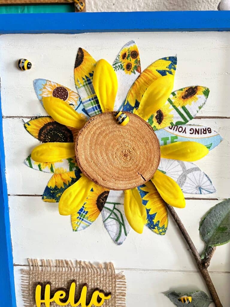 Close up of the wooden round center with little bumble bee embellishments.