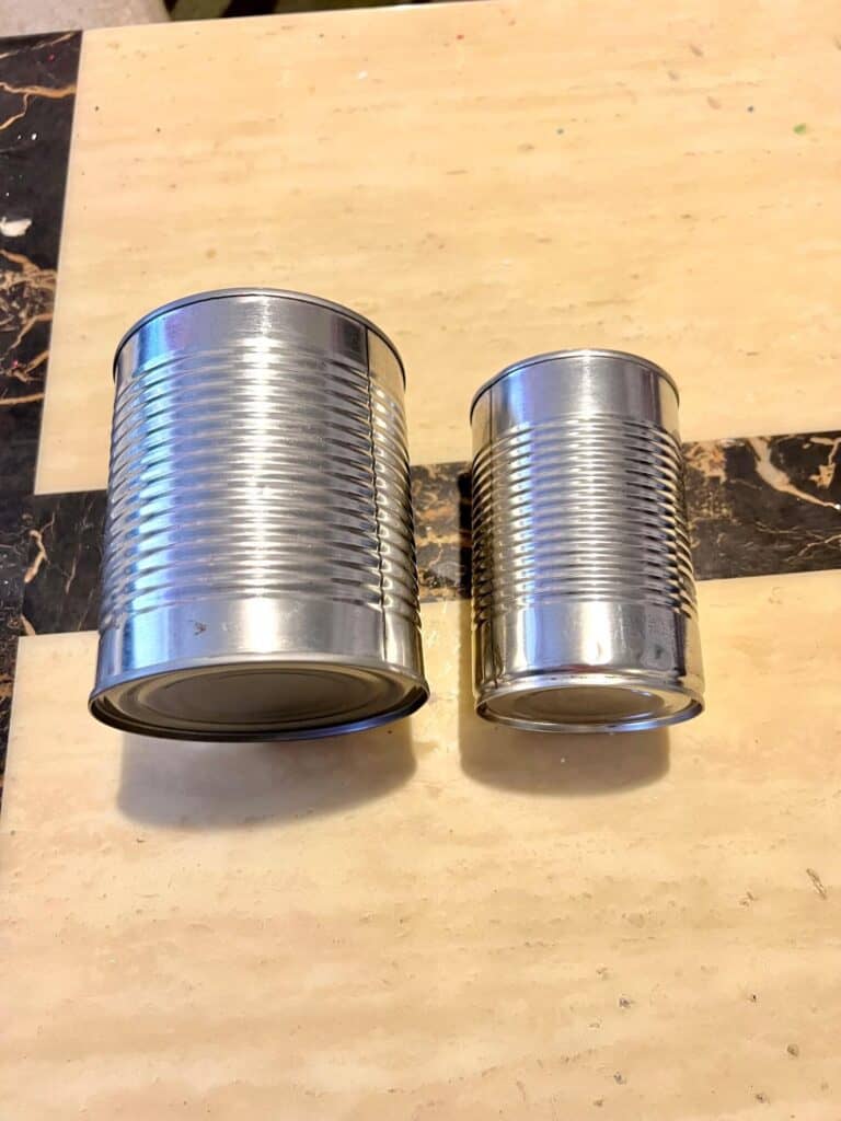 Two aluminum tin cans, one small and one large.