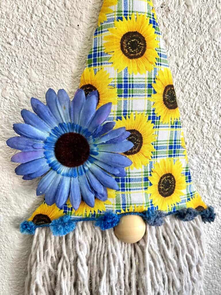 Close up of the blue sunflower on the bottom of the dollar tree gnome hat.