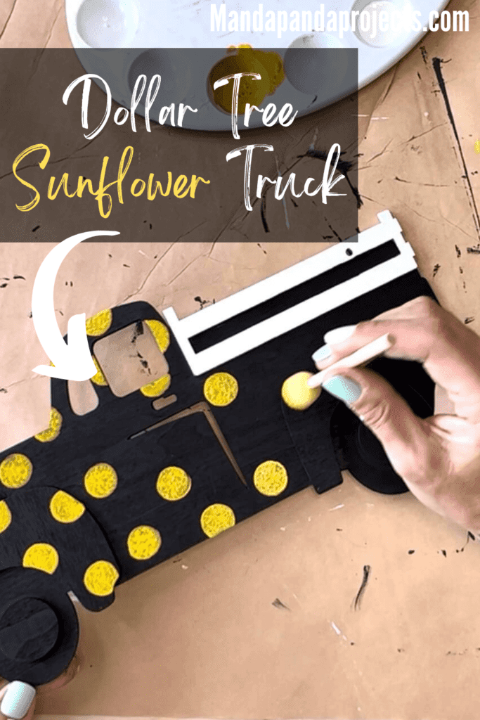 In progress pic of using a spouncer to make yellow polka dots on the black wooden truck.