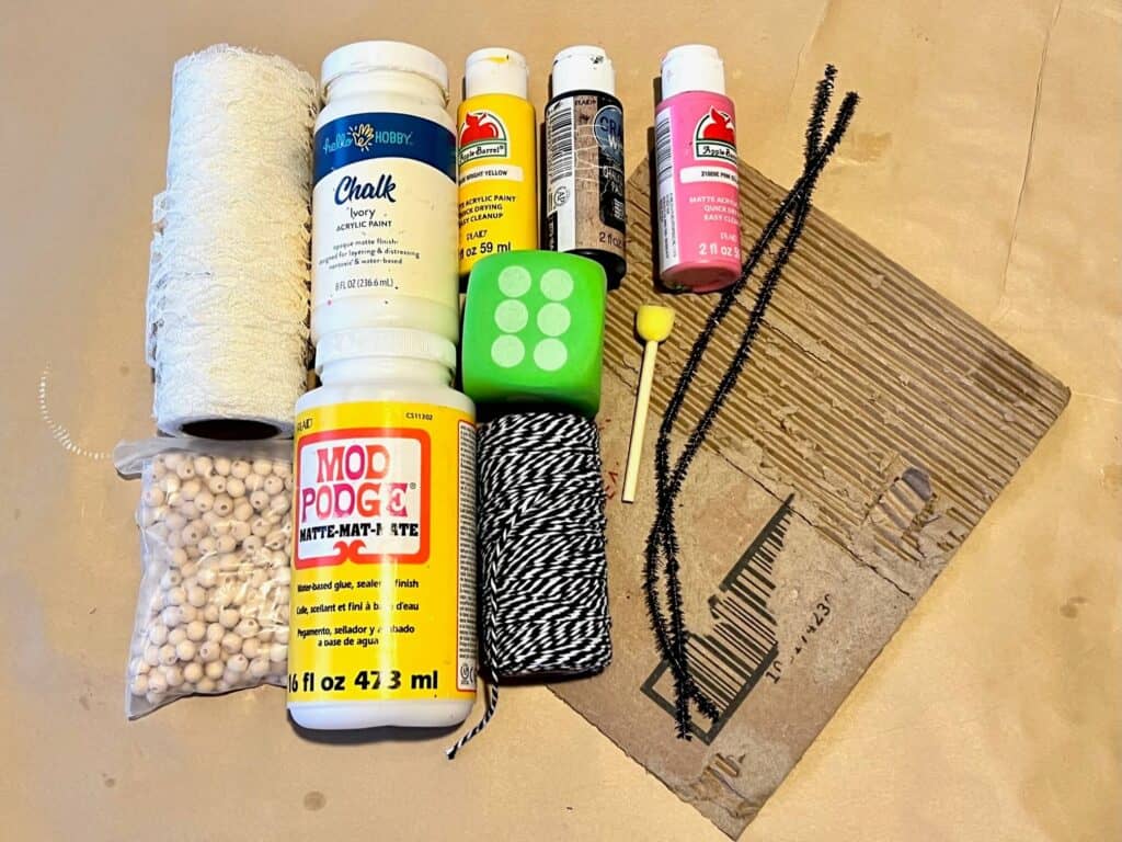Supplies needed to make a whimsy bumblebee out of the dollar tree foam dice and cardboard.
