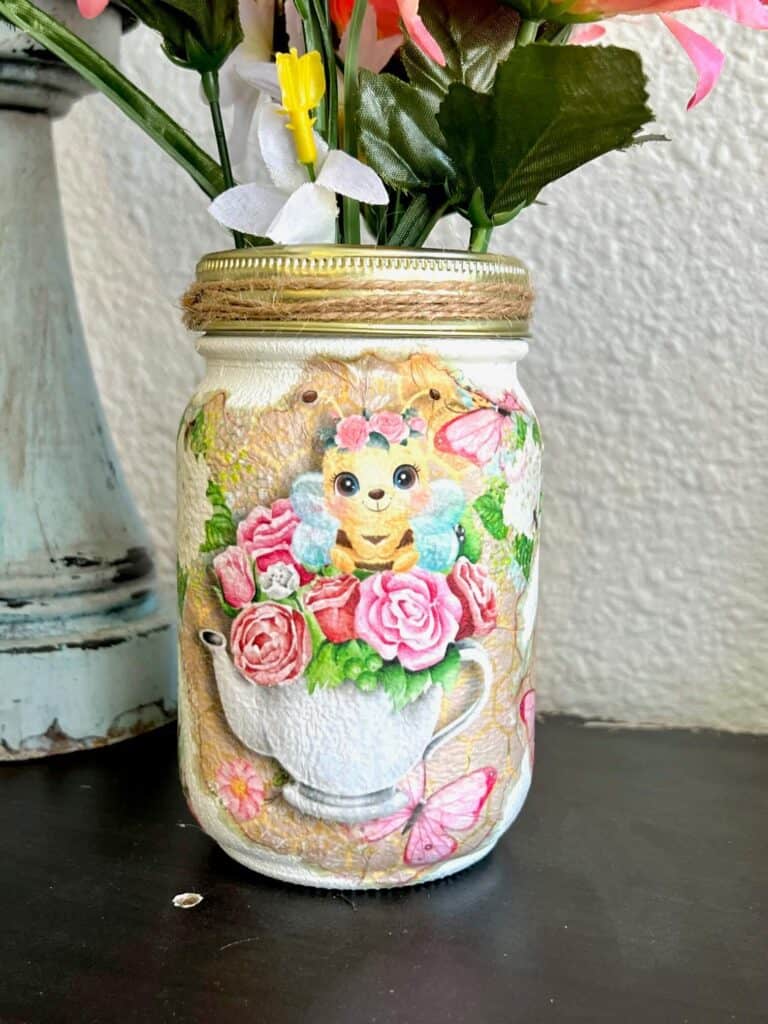 Close up of the Sweet Pea Bumblebee print on tissue paper, mod podged to the front of a Mason Jar.