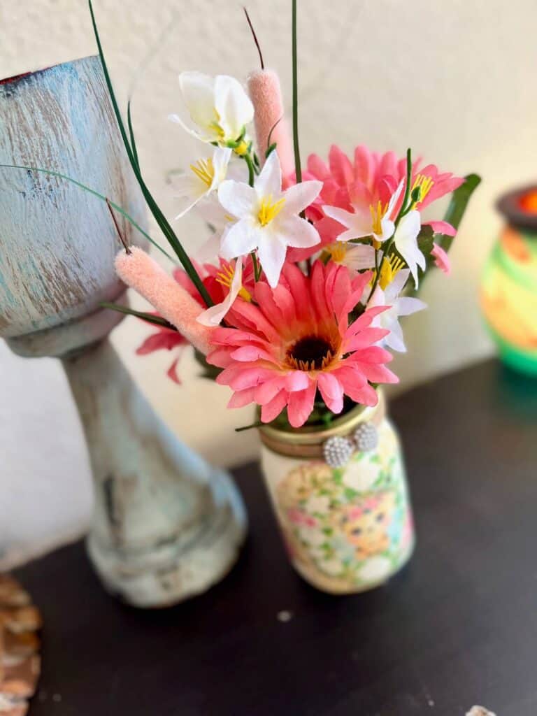 Pink daisys and cat tails, with white delicate florals inside the Mason Jar.
