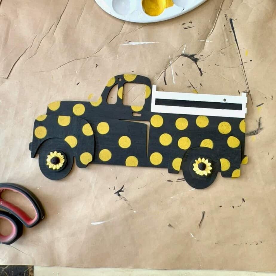 Glue a mini paper sunflower to the center of each truck tire.