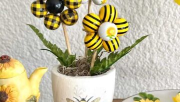 DIY Wood Bead Flowers made with sunflower and bee wood beads in a mini terra cotta pot with a napkin decoupaged and sitting on top of a tiered tray as summer decoration.
