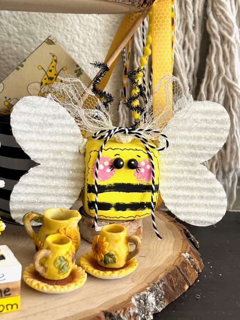 DIY Dollar Tree Foam Dice Whimsy Bumblebee summer tiered tray decor idea with diamond dust wings and a lace bow.