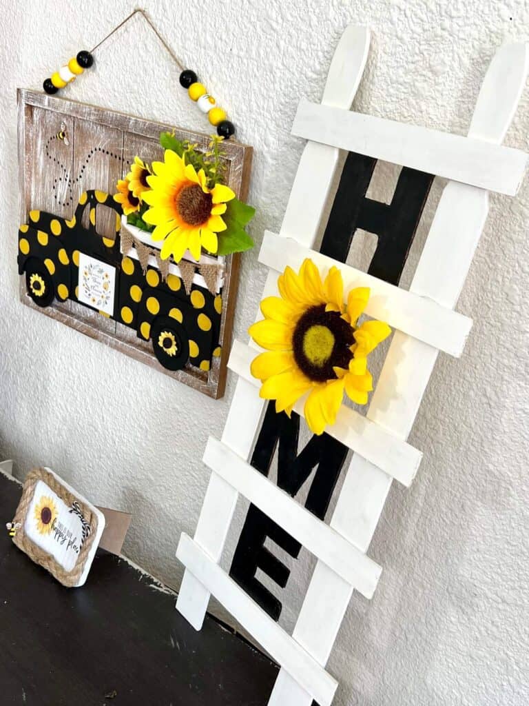 DIY paint stick HOME ladder with a sunflower "O" next to the yellow polka dot sunflower truck.