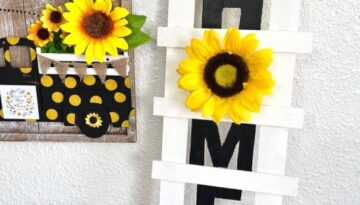 DIY Paint Stick Decor Ladder with the word HOME and a sunflower "O" for easy and affordable way to decorate your home on a budget.