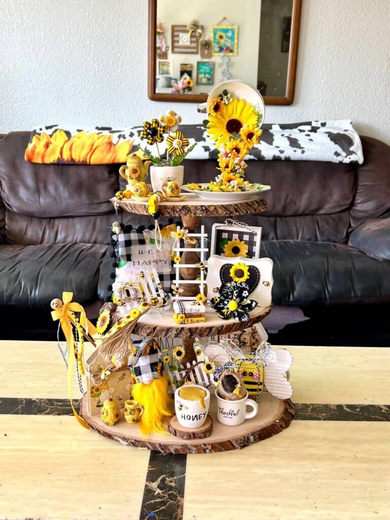 Rustic Handmade Summer Sunflower and Bumblebee themed 3 tiered tray decorated and styled with tons of handmade crafts and decor that are yellow, black, and white.