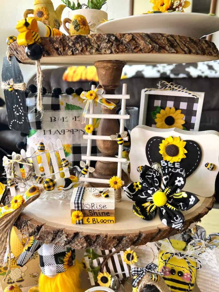 Middle tier of the 3 tiered tray showing the sunflower bee ladder, mini jenga blocks bookstack, bee kind heart block, and buffalo check sunflower decor.