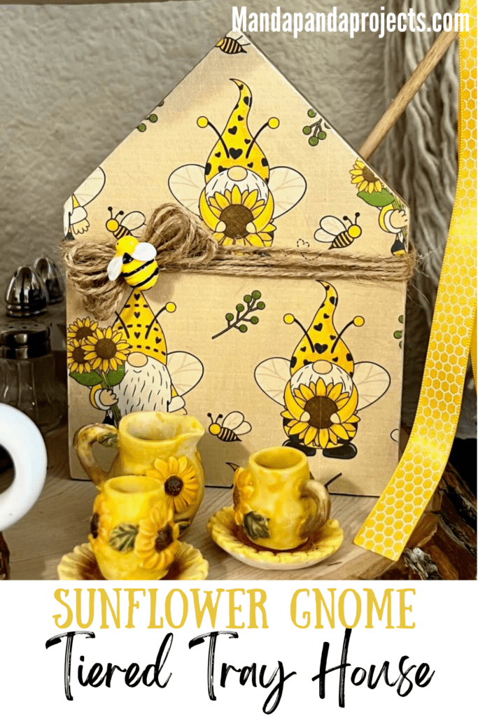 Mini Dollar Tree wooden house with sunflower bee gnome paper mod podged to it and twine wrapped around it to make an easy and cute tiered tray sitter for decor.