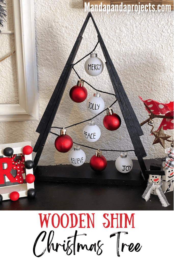 Black A frame wooden shim Christmas Tree with small red and white Rae dunn inspired bulb ornaments on black string.