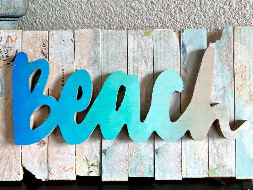 Dollar Trees wooden word, Beach, painted Ombre colored from deep blue to light blue to teal, to tan to white to look like the beach.