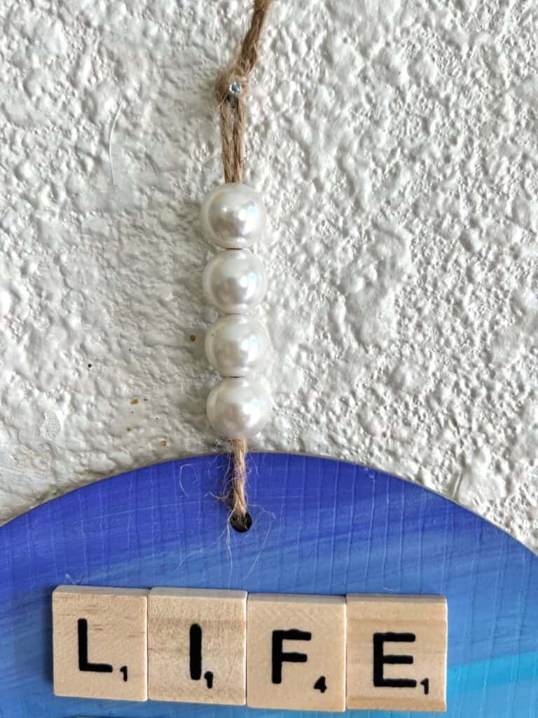 Pearl bead hanger on the top of the project.