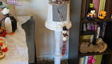 Vintage Thrift Store gumball machine decor with ornaments and a santa hat or messy bow and wood bead garland ornament.