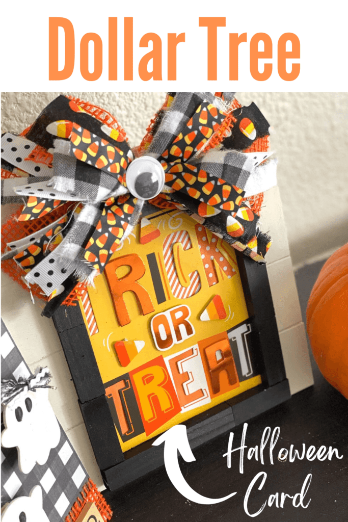 DIY Dollar Tree Trick or Treat Frame made with a Halloween card and a huge messy bow with candy corn, orange, black, and a jumbo googly eye in the center.