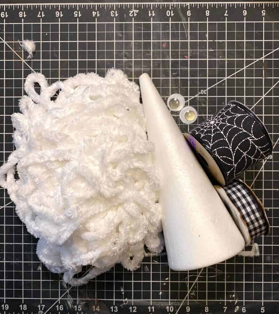 Supplies needed to make the Foam Cone Mummy with white velvety yarn, googly eyes and black and white ribbon.