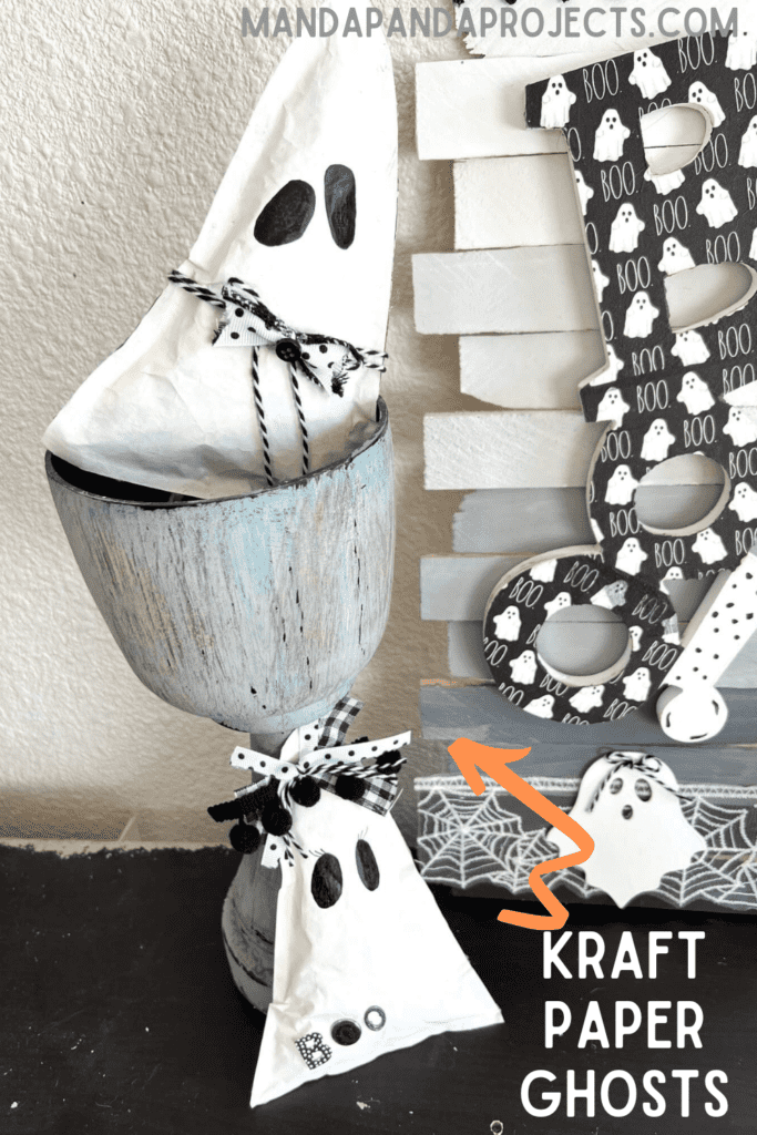 Kraft Paper Ghosts DIY easy and affordable Halloween decor. Boy and girl triangle shaped ghosts with black and white bow and bow tie and the word BOO, with 2 black eyes and no mouth.