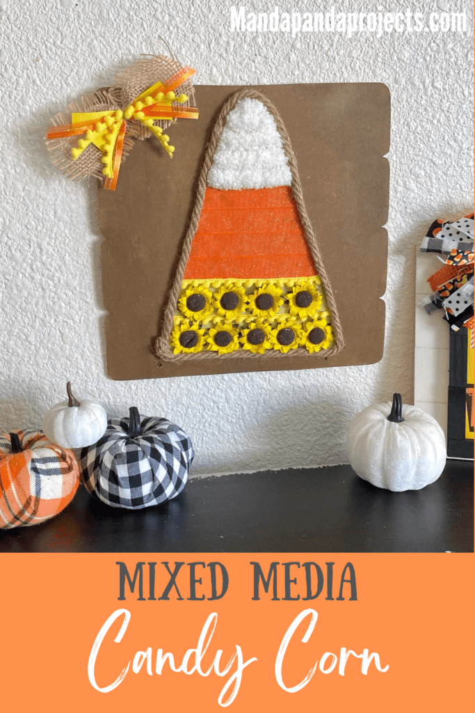 Dollar Tree Mixed Media Candy Corn craft with white chunky yarn, orange ribbon and yellow sunflowers with Jute rope around the edge and a cute bow in the corner.