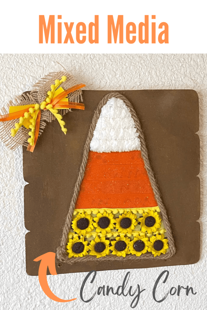 Dollar Tree Mixed Media Candy Corn craft with white chunky yarn, orange ribbon and yellow sunflowers with Jute rope around the edge and a cute bow in the corner.