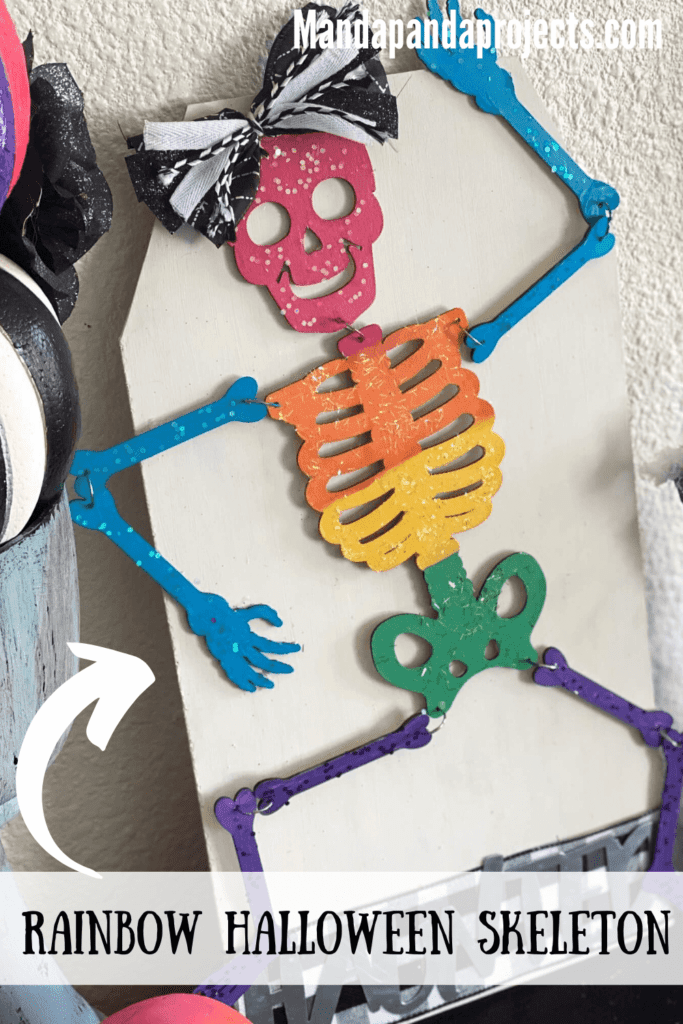 DIY Dollar Tree Rainbow Halloween Skeleton with a haunted sign and a black and white cute bow for your DIY decorations.