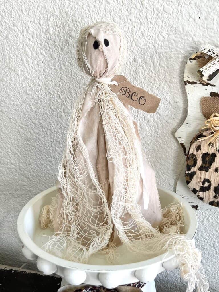 DIY Primitive Halloween Rag Ghost made with creepy cheese cloth and muslin that is stained with antique wax to look grungy with a hangtag around his neck that says "BOO".