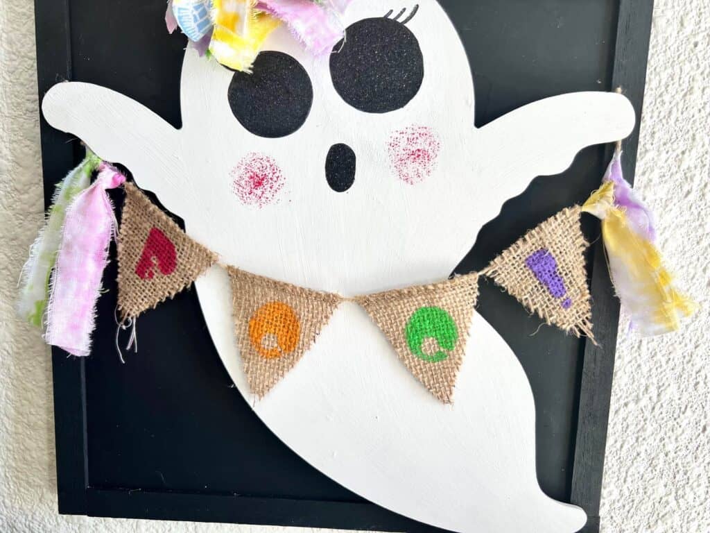 Rainbow burlap pendant banner with the word BOO and fabric tassels at each end.