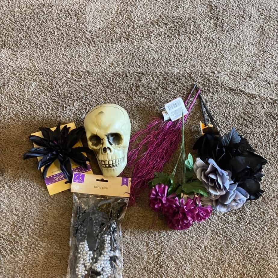 Supplies needed to make a Halloween decor centerpiece from a dollar Tree plastic skull.