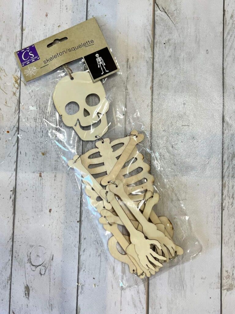Dollar Tree wooden skeleton in the package.