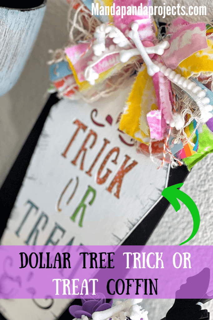 Dollar Tree Trick or Treat Wooden Coffin makeover craft for a DIY Halloween decor piece in a colorful rainbow theme with a big messy bow, cross bones, and a spider on a black background.