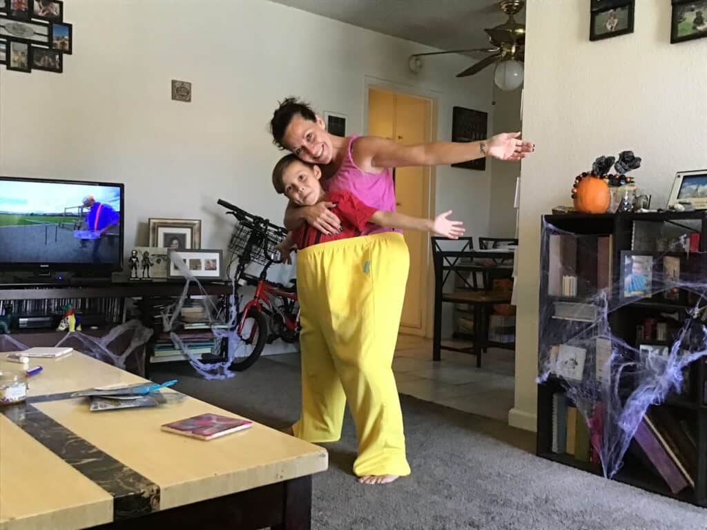 Amanda and Justice together inside a huge pair of yellow pants, playing around having fun.