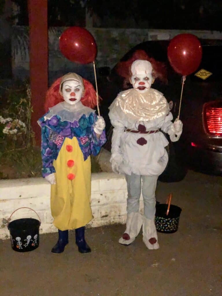 DIY Pennywise the Clown Halloween costumes with the original version of pennywise, the new movie version. 2 different handmade costumes with 2 kids wearing them.